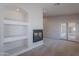 Carpeted living room featuring fireplace and patio access through double doors at 13305 W Colter St, Litchfield Park, AZ 85340