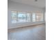 Bright and open living room with large windows showcasing outdoor views, neutral colors and luxury vinyl flooring at 13305 W Colter St, Litchfield Park, AZ 85340