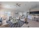 Open-concept living room featuring stylish furniture, modern lighting, and seamless flow to the dining area and kitchen at 13305 W Colter St, Litchfield Park, AZ 85340