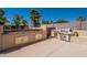 Well-equipped outdoor kitchen with a built-in barbecue grill, sink, and storage cabinets for entertaining at 13305 W Colter St, Litchfield Park, AZ 85340
