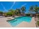 Relaxing backyard pool with mature trees, landscaping, a spa, and a tanning shelf at 13305 W Colter St, Litchfield Park, AZ 85340