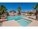 Beautiful backyard pool with palm trees, a spa, and a tanning shelf at 13305 W Colter St, Litchfield Park, AZ 85340