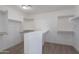 Organized walk-in closet with ample hanging space and shelving; built-in vanity at 13305 W Colter St, Litchfield Park, AZ 85340
