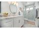 Elegant bathroom with marble countertops, modern fixtures, and glass-enclosed shower at 13629 N 71St Dr, Peoria, AZ 85381