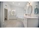 Large bathroom featuring dual vanities, a soaking tub, glass block window, and neutral tile flooring at 13629 N 71St Dr, Peoria, AZ 85381