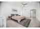 Spacious bedroom with high ceilings, neutral walls, a ceiling fan, and a view of a connecting bathroom at 13629 N 71St Dr, Peoria, AZ 85381