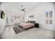 Bright primary bedroom featuring a comfortable bed, ceiling fan, and natural light at 13629 N 71St Dr, Peoria, AZ 85381