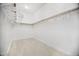 Empty walk-in closet with neutral walls and baseboards, and a rod with hangers ready for use at 13629 N 71St Dr, Peoria, AZ 85381