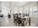 Bright dining area featuring modern shutters, wood furniture and an exterior view of the pool at 13629 N 71St Dr, Peoria, AZ 85381