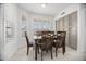 Bright dining room with a view of the lush exterior, light tile, and built in buffet at 13629 N 71St Dr, Peoria, AZ 85381