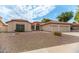 Inviting beige house with a tile roof and well-kept desert landscaping for easy maintenance at 13629 N 71St Dr, Peoria, AZ 85381
