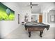 Entertainment room with billiard table, tiled floor, and modern art at 13629 N 71St Dr, Peoria, AZ 85381