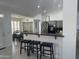 Open kitchen with stainless steel appliances, breakfast bar, and gray cabinetry at 13629 N 71St Dr, Peoria, AZ 85381