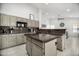 Neutral kitchen with breakfast bar, sleek countertops, and a view to the dining area at 13629 N 71St Dr, Peoria, AZ 85381