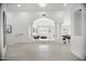 Open-concept living room with decorative columns, game table, and neutral colors at 13629 N 71St Dr, Peoria, AZ 85381