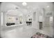 Open-concept living room with decorative columns, game table, and neutral colors at 13629 N 71St Dr, Peoria, AZ 85381