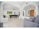 Open-concept living space with high ceilings, tile floors, and white walls and trim at 13629 N 71St Dr, Peoria, AZ 85381
