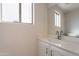 Bathroom sink and vanity with white cabinets, reflecting a clean and modern aesthetic at 13706 N 130Th Ave, El Mirage, AZ 85335