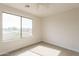 Neutral bedroom with a ceiling fan, large window and carpeted floor at 13706 N 130Th Ave, El Mirage, AZ 85335