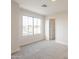 Bright bedroom with large window and neutral carpet, offering a serene and comfortable space at 13706 N 130Th Ave, El Mirage, AZ 85335