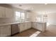 Kitchen with white cabinets, marble countertops, stainless steel appliances, and view into dining area at 13706 N 130Th Ave, El Mirage, AZ 85335