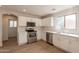 Modern kitchen with white cabinets, stainless steel appliances, and marble countertops at 13706 N 130Th Ave, El Mirage, AZ 85335