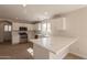 Updated kitchen with white cabinets, marble countertops, and stainless steel appliances at 13706 N 130Th Ave, El Mirage, AZ 85335
