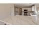 Bright kitchen featuring white cabinets, stainless appliances, and gorgeous countertops at 13706 N 130Th Ave, El Mirage, AZ 85335