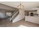 Open-concept living space featuring the kitchen, stairs, and dining area at 13706 N 130Th Ave, El Mirage, AZ 85335