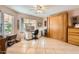 Comfortable bedroom with a desk, large window, and a built-in Murphy bed at 14680 W Morning Star Trl, Surprise, AZ 85374