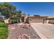 Inviting home featuring a two-car garage, desert landscaping, and solar panels at 14680 W Morning Star Trl, Surprise, AZ 85374