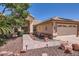 Inviting home featuring a two-car garage, walkway, and desert landscaping at 14680 W Morning Star Trl, Surprise, AZ 85374