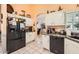 Well-lit kitchen featuring white cabinets, black appliances, and granite countertops at 14680 W Morning Star Trl, Surprise, AZ 85374