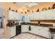 Bright kitchen featuring white cabinets, stone countertops, and tile floors at 14680 W Morning Star Trl, Surprise, AZ 85374