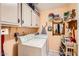 Functional laundry room with a washer, dryer, and plenty of storage cabinets at 14680 W Morning Star Trl, Surprise, AZ 85374