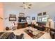 Cozy living room featuring tile floors, ample seating, and a ceiling fan at 14680 W Morning Star Trl, Surprise, AZ 85374