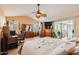 Relaxing main bedroom featuring tile floors, vaulted ceiling, dresser, and sliding glass doors at 14680 W Morning Star Trl, Surprise, AZ 85374