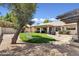 Expansive backyard with lush lawn, covered patio, mature tree, and inviting swing offers relaxation at 14821 N 42Nd St, Phoenix, AZ 85032