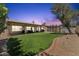 Spacious backyard featuring an outdoor living area, lush turf grass, mature landscaping, and privacy at 14821 N 42Nd St, Phoenix, AZ 85032