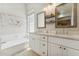 Elegant bathroom featuring double sinks, modern fixtures, and a luxurious soaking tub for ultimate relaxation at 14821 N 42Nd St, Phoenix, AZ 85032
