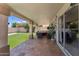 A covered patio featuring tile flooring, a cozy seating area, and a serene view of the backyard at 14821 N 42Nd St, Phoenix, AZ 85032
