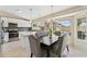 Bright dining area featuring a table set for six next to the kitchen, offering both style and convenience at 14821 N 42Nd St, Phoenix, AZ 85032