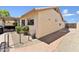 Side view of stucco home with desert landscaping, featuring a brick walkway and gated yard at 14821 N 42Nd St, Phoenix, AZ 85032