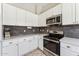 Clean kitchen featuring white cabinets, stainless appliances, and ample counter space at 14821 N 42Nd St, Phoenix, AZ 85032