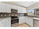 Well-equipped kitchen with stainless steel appliances and white cabinets at 14821 N 42Nd St, Phoenix, AZ 85032