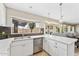 Bright kitchen featuring a stainless steel dishwasher, white cabinets, and a window at 14821 N 42Nd St, Phoenix, AZ 85032