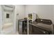 Laundry room with side by side washer and dryer, with built-in shelving and tile flooring at 14821 N 42Nd St, Phoenix, AZ 85032