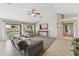 Bright living room featuring tile floors, a ceiling fan, and sliding glass doors to the backyard at 14821 N 42Nd St, Phoenix, AZ 85032