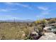 Charming back patio with gorgeous desert views, lush flowering plants, and outdoor seating area at 15620 E Palomino Blvd, Fountain Hills, AZ 85268