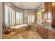 Elegant bathroom featuring a soaking tub, a tiled shower, and cabinetry at 15620 E Palomino Blvd, Fountain Hills, AZ 85268